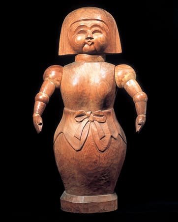 A wooden carving of a human figure