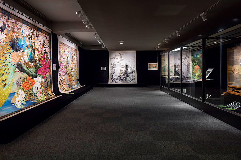 An exhibition room displaying large textile works