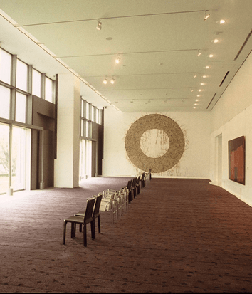 A large exhibition space lined with chairs