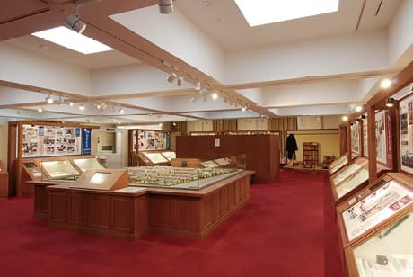 An exhibition room lined with display cases of materials