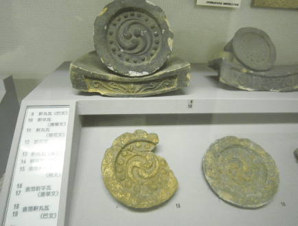 A display case lined with roof tiles