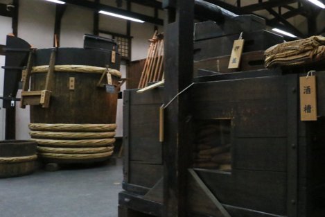 An exhibit displaying wooden tubs and barrels