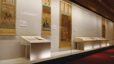 An exhibition room displaying hanging scrolls