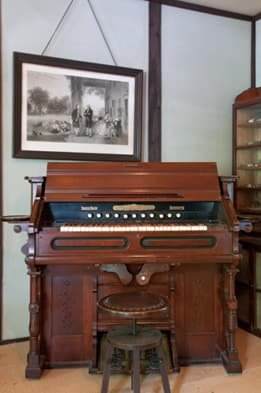 A foot-pumped organ with a stool