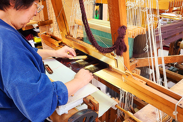 Hands engaged in weaving