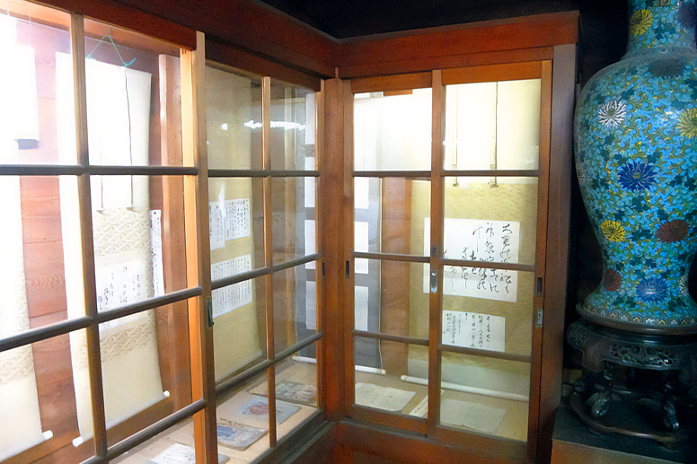 Letters and materials displayed in a glass case
