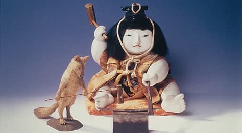 A doll placed alongside small animals