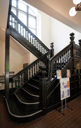A wooden staircase with a handrail