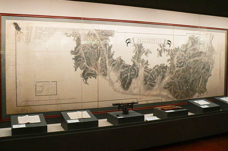 An exhibit displaying large drawings and archival materials