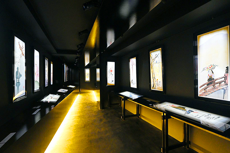 An exhibition room displaying framed works
