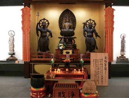 An altar display lined with Buddhist statues