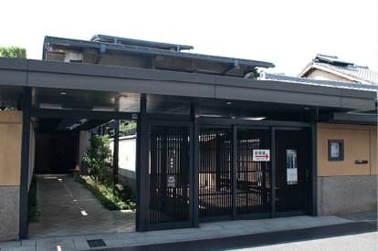 The entrance to an art museum with a lattice door