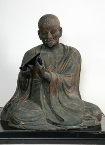 A seated statue of a monk